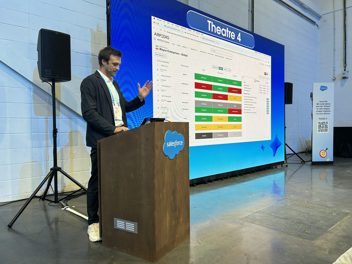 ARPEDIO presenting live on stage at the Agentforce World Tour London Demo Jam, with the stakeholder relationship view on the big screen